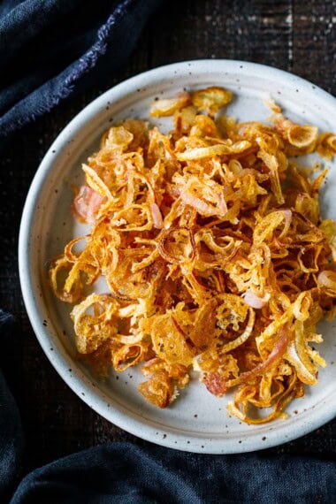 These crispy fried shallots are light, crisp, and flavorful. Easy to make, use them as a crunchy topping for sides, soups, or anything that needs a little boost of texture and punchy flavor.