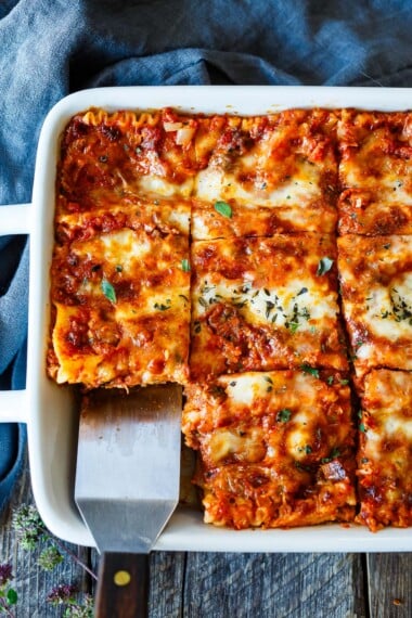 This classic lasagna recipe is absolutly delectable! Made with a rich tomato-meat sauce, three kinds of cheeses, and savory Italian spices, it's easy to make and always a crowd-pleaser.