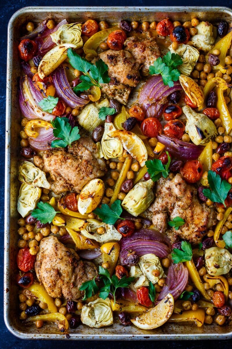 Mediterranean Chicken with veggies, chickpeas, olives and herbs. A delicious sheet pan dinner that is easy to make and easy to clean up!&nbsp;
