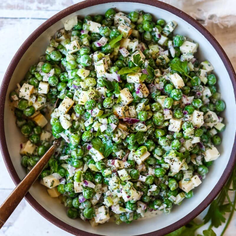 A healthy spruced-up version of classic Pea Salad tossed in a creamy Greek yogurt dressing with lots of fresh herbs and smoked cheddar cheese. Tangy, delicious and all made in one bowl in about 20 minutes! Vegetarian, Vegan adaptable.&nbsp;